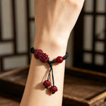 Carved Cinnabar Pixiu Braided Bracelet with Lotus Finials (朱砂精雕貔貅黑编绳手链) thumb